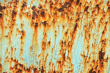 Peeling paint on the wall. Panorama of a concrete wall with old cracked flaking paint.