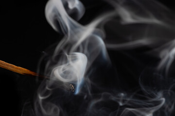 Smoke from a match that was just put out, isolated on black background