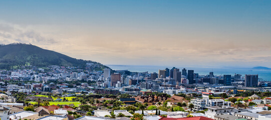 Fototapeta na wymiar Panorama shot of Cape Town city centre and signal hill with atlantic ocean in the background during sunset, Cape Town, South Africa