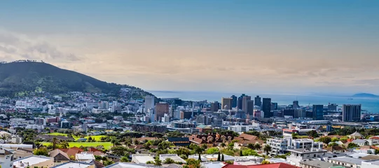 Papier Peint photo Montagne de la Table Panorama shot of Cape Town city centre and signal hill with atlantic ocean in the background during sunset, Cape Town, South Africa
