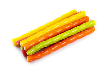 Multicolored jelly candies in the shape of the sticks on a white background