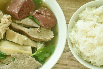 boiled pork blood and entrails with chop pork in soup on bowl dipping chili sauce eat couple plain rice 