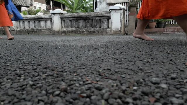 Buddhist monks feet close up. Monks strolling through the streets of Luang Prabang, Lao during their morning alms collection.
