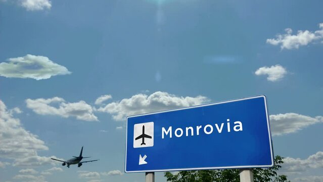 Jet airplane landing in Monrovia, Liberia. Plane city arrival with airport direction sign. Travel, business, tourism and plane transport concept.