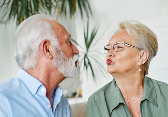 woman couple senior man happy internet love tablet together mature active elderly retirement computer technology online using caucasian home adult family romance