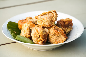 Close-up photo of Gorengan Tahu Walik on white plate. Concept for junk food, unhealthy, diet, calories, bad fat, carbohydrate, snacks, cafe, fast food.