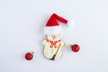 Christmas gingerbread in the shape of a snowman with Santa Claus hat on the white background. Copy space.