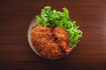 Deep fried chicken cutlet and salad vegetables