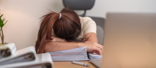 Stressed Asian woman having Tired and Sleepy while working, female businesswoman using laptop with headache at office, Exhausted woman with computer at home late night. Overload and Overworked