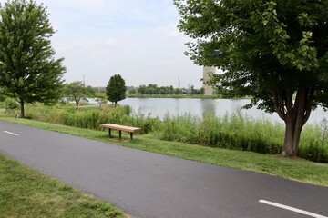 The empty park bench overlooking the lake in the park.