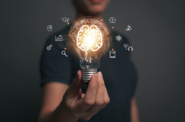 Woman holding light bulb. Online education concept. Finding ideas for work Planning student...