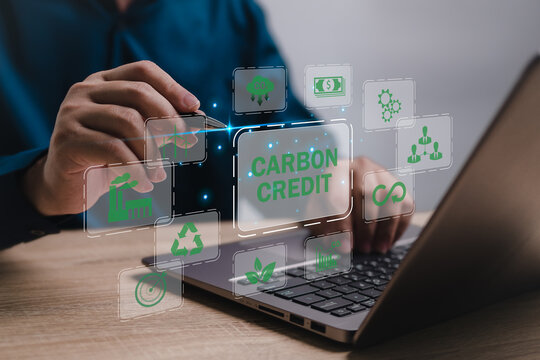 Carbon Credit Market and business management concept, Businessman use laptop analyzing data Carbon Credit Market idea reduce the carbon dioxide in the air Control industrial and environmental system - Powered by Adobe