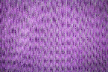 Abstract lavender colored mesh fabric background with vignette top view, macro photography