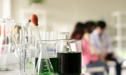 STEM education concept. Asian children in laboratory research an experiment exam with chemistry beaker. The new education system in a classroom include Science, Technology, Engineering and Mathematics