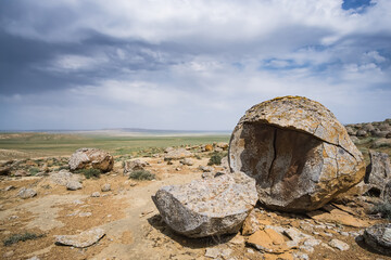 Unusual spherical shape of stones in the Kazakh steppe Mangistau, valley of balls in nature Torysh - obrazy, fototapety, plakaty
