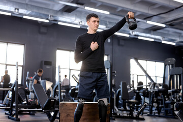 active ambitious sportsman raising kettlebell, working out with sport equipment, tool, close up...