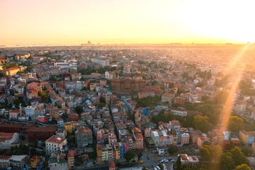 Aerial drone view of Istanbul, Turkey. Halic Bridge with multiple moving cars, multiple residential buildings on the both sides of the Golden Horn waterway, greenery, downtown on the background