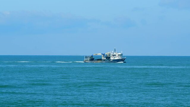 Fishing Vessel Goes To Sea To Catch Fish. Ship Floats On Sea Surface Leaving Path Of Sea Foam Water. Real time.