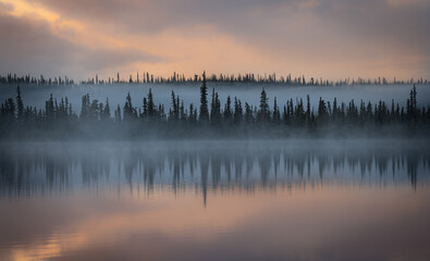 Sunrise over a lake in the boreal forest near the Nabesna Road in Wrangell St. Elias National Park,...