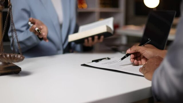 Lawyer and legal advice, The legal counsel is discussing the terms of the agreement and signing the contract.