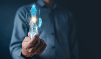 idea, plan, document, report, goal, lightbulb, target, investment, management, solution. close up to hand hold lighten lightbulb arrow growth up HUD in middle. inspiration use helpful to hit the goal.