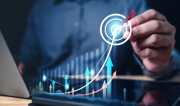 development, growth, plan, progress, success, target, financial, goal, investment, management. one hand typing keyboard another drawing indicator to check growth of performance for hit the goal.