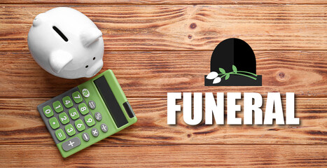 Piggy bank and calculator on wooden background. Money savings for funeral