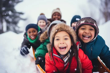 Foto op Plexiglas Group of diverse happy multi-ethnic children riding sledge and having fun outdoors in snow, winter time © Jasmina