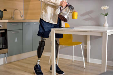 handicapped male lead usual lifestyle as other people, stand in artificial fake legs spending...