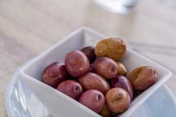 Closeup, olives seasoned in vinegar and salt.