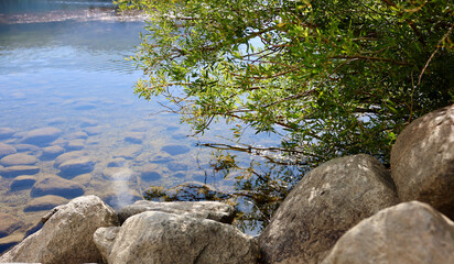 boulders along the shoreline of the mountain lake