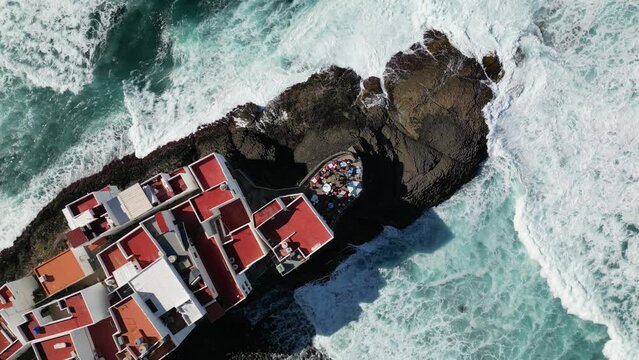 raging seas crashing into houses on the cliffs of the canary islands 4k drone video 