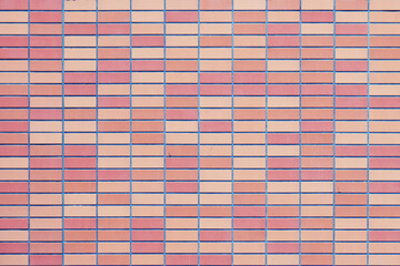 The texture of a red smooth brick wall. Large stone wall background