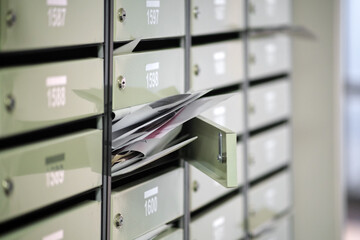 Mailboxes in the condominium are littered with correspondence, overflowing. Paper letters lie in an...