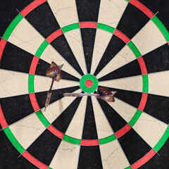 Dartboard with red and green arrows in the center of it