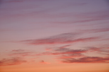 The sun painted the clouds with shades of pink and orange as it set.