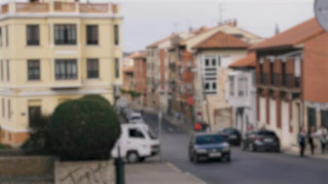 Astorga street along which cars drive, tourists walk. City buildings in the background. Background, blurry video.