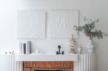 White minimalist loft interior with fireplace, mock up picture frame and minimalist home decor. Real photo template.