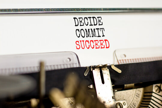Decide commit succeed symbol. Concept word Decide Commit Succeed typed on beautiful retro old typewriter. Beautiful white paper background. Business decide commit succeed concept. Copy space.