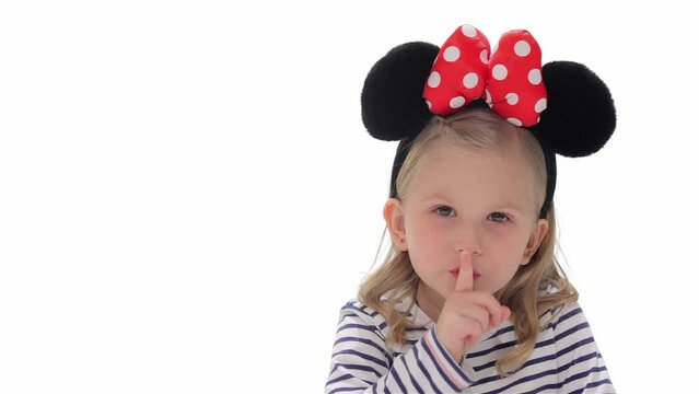 Little girl makes silence gesture