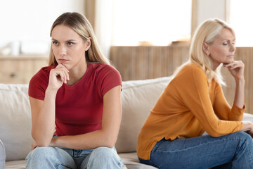 Angry women millennial adult daughter and mature mother sit aside