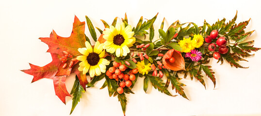 decoration from colorful autumnal leaves, berries and flowers, creative craft