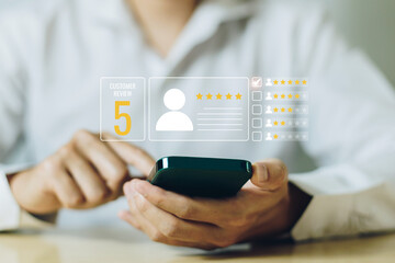 Customer holding smartphone giving a five star rating with rating feedback scale. Concept of service rating, satisfaction and feedback