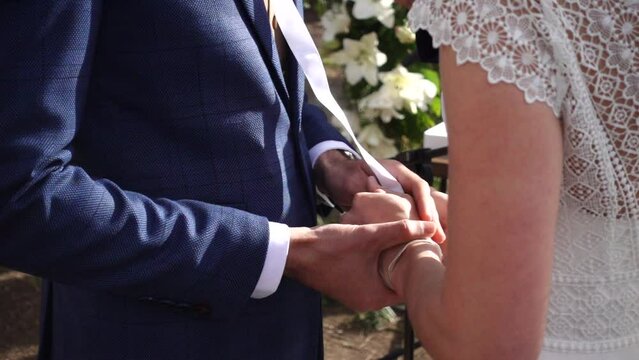 close-up of couple about to get married while holding hands in slow motion 240 fps