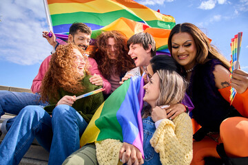 Group multi-ethnic excited people gathered to celebrate gay pride day in street. Diverse joyful...