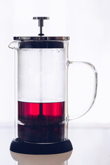 Red hibiskus hot tea in French press © Nelli Kovalchuk