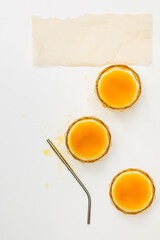 Three glasses of orange juice.