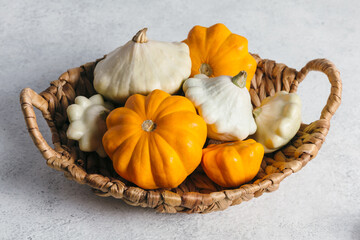 Autumn composition for Thanksgiving Day with variety of pattypan squashes on white kitchen table.