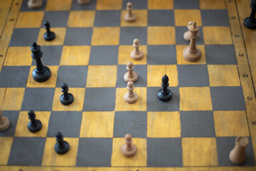 Playing chess in tournament. Chess pieces on board. Sports competition at school. Gaming prowess.
