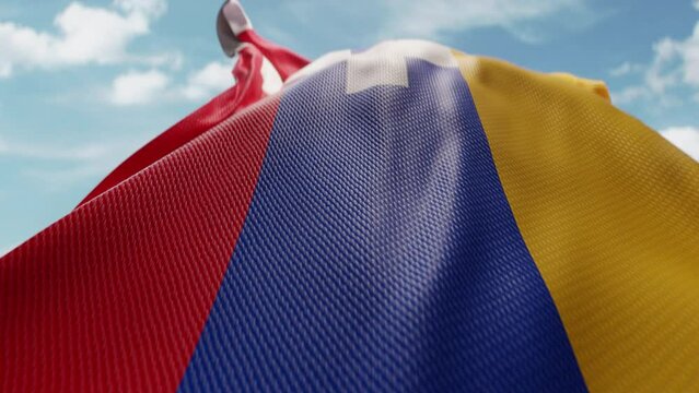 Wavy flag of Artsakh blowing in the wind in slow motion. Waving official Artsakh flag team symbol abstract vertical background. Blue sky with clouds. World countries flying flags concept